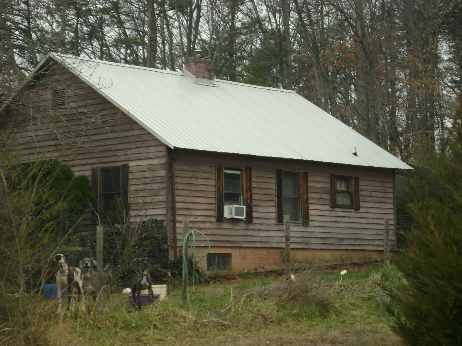 White metal roof on an old wood sided farmhouse, from a Metal Roof Installation job in Copiague